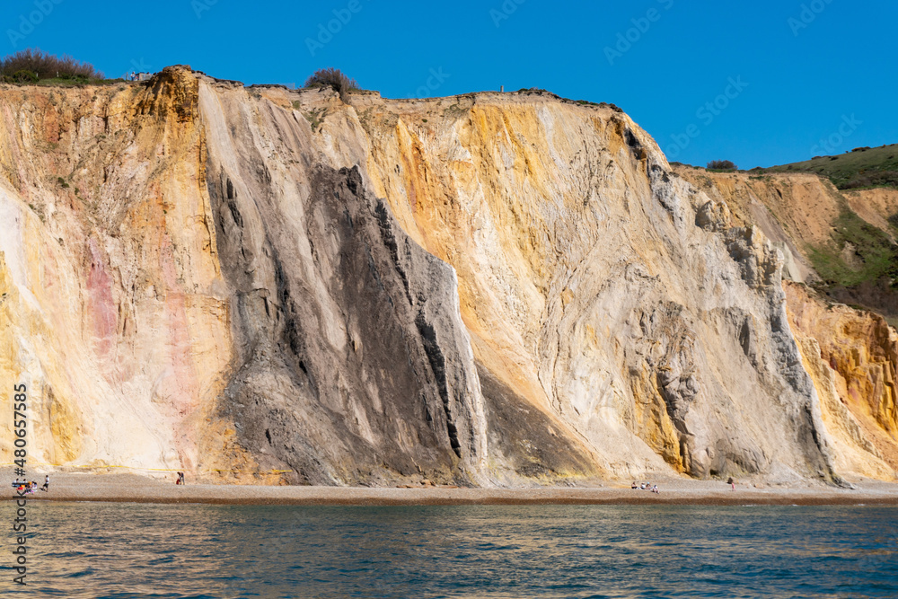 View of multicoloured sand cliffs in Alum Bay, near the Needles, in Isle of Wight, United Kingdom