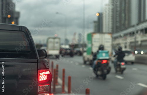 Blur photo of traffic and transportation in the city in the evening with dark rainy clouds coming in the background. Big town lifestyle concept © Sura Nualpradid