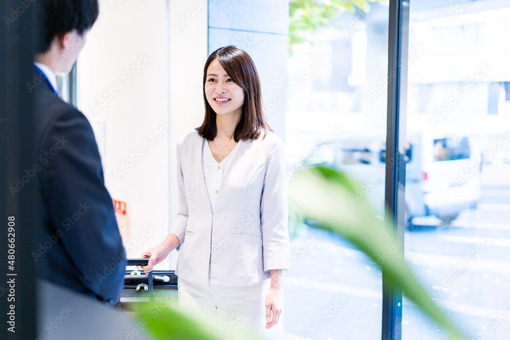 ホテルスタッフと話す若い女性 ホテルスタッフと話す若い女性