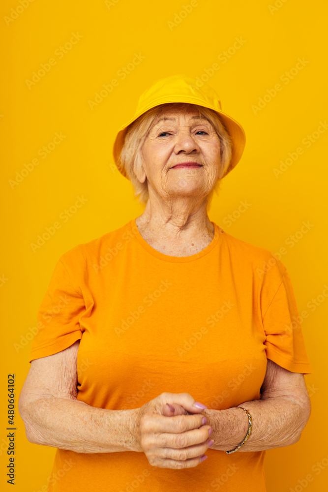 Portrait of an old friendly woman happy lifestyle in a yellow headdress close-up emotions Portrait of an old friendly woman happy lifestyle in a yellow headdress close-up emotions