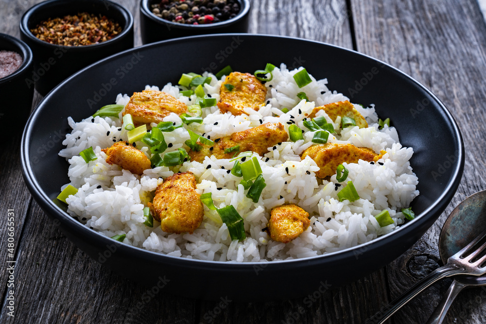 Chicken nuggets with rice and vegetables on wooden table
Chicken nuggets with rice and vegetables on wooden table