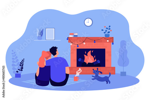 Embraces of couple sitting on floor near fireplace at home