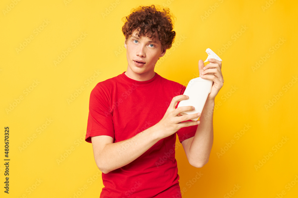 portrait of a young curly man detergent posing emotion yellow background unaltered portrait of a young curly man detergent posing emotion yellow background unaltered