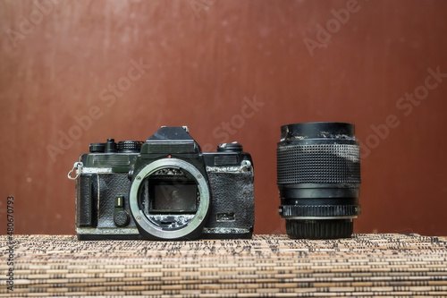 Collection of old camera and lens with brown background photo