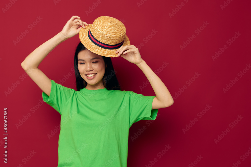 woman with Asian appearance smile green t-shirt hat posing fashion isolated background unaltered woman with Asian appearance smile green t-shirt hat posing fashion isolated background unaltered