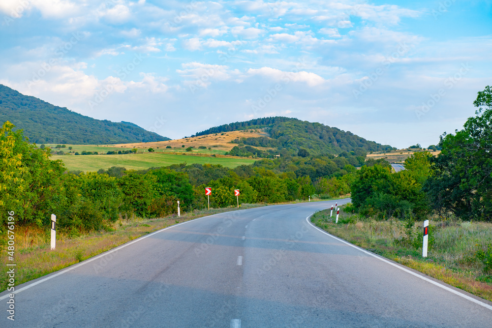 Obraz premium scenic asphalt road towards the mountains goes