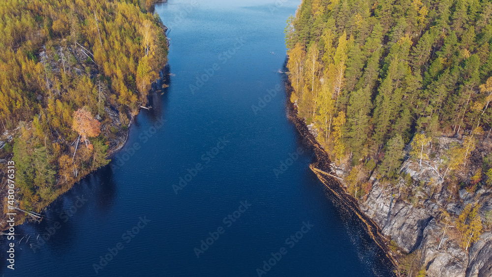 Lake in Karelia among larch trees, Russia. Beautiful autumn season landscape with river and forest stock photography