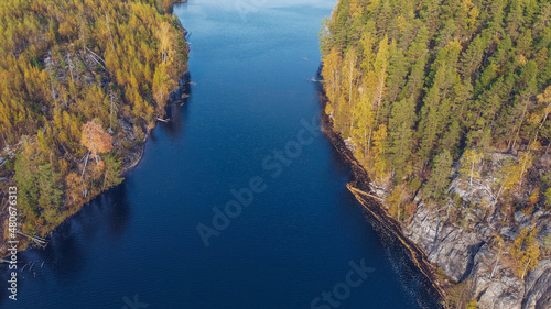 Lake in Karelia among larch trees, Russia. Beautiful autumn season landscape with river and forest stock photography