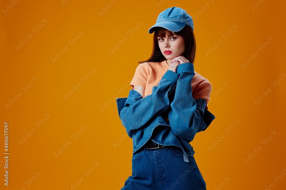 Beautiful fashionable girl denim cap red lips glamor fashion color background unaltered Beautiful fashionable girl denim cap red lips glamor fashion color background unaltered