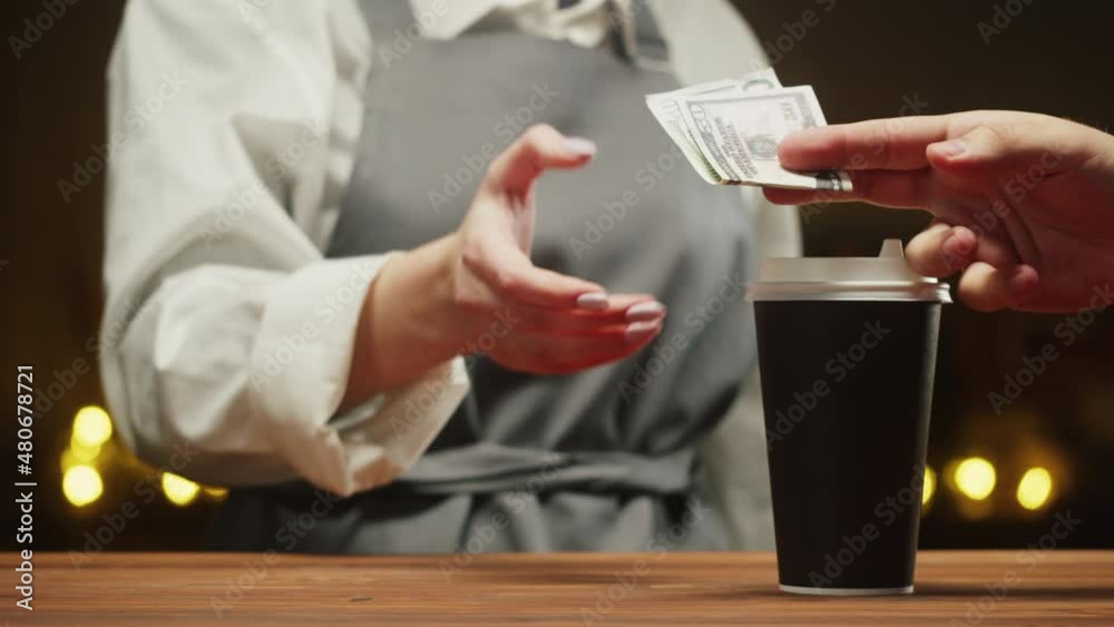 Buying coffee or tea and paying by cash close-up. Shopping in restaurant or cafe. Buying coffee or tea and paying by cash close-up. Shopping in restaurant or cafe.
