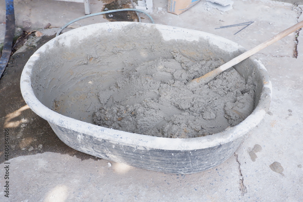 Cement in a bucket mixed with water ready for construction. Cement in a bucket mixed with water ready for construction.