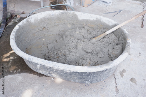 Cement in a bucket mixed with water ready for construction. © krongthip