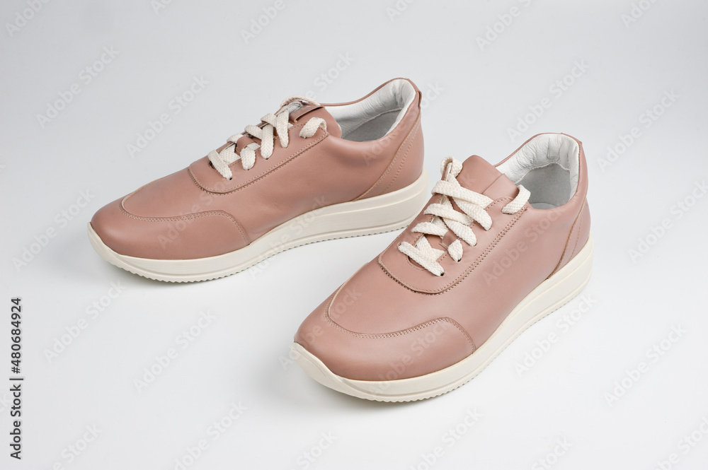 Light brown faux leather shoes with laces. Close-up shot. Light brown faux leather shoes with laces. Close-up shot.