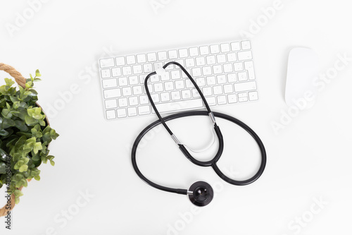 Medical stethoscope, keyboard and mouse on the desktop doctor