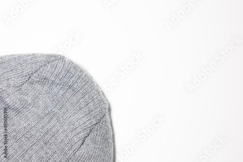 Grey wool fabric knitted lying on white background with space for text