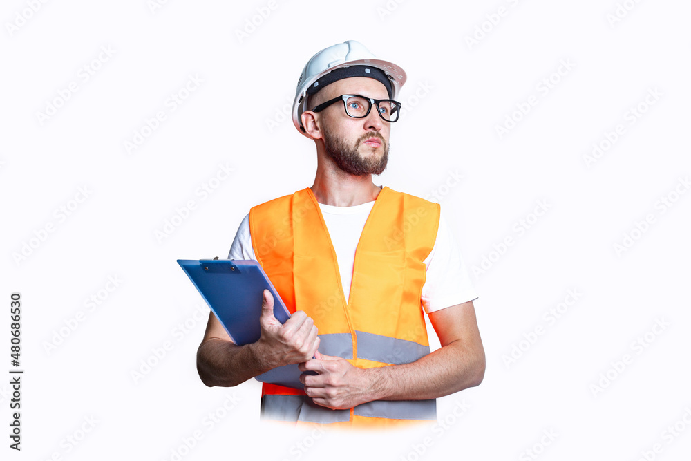 Young man in construction clothes, with a clipboard on a light background. Young man in construction clothes, with a clipboard on a light background.