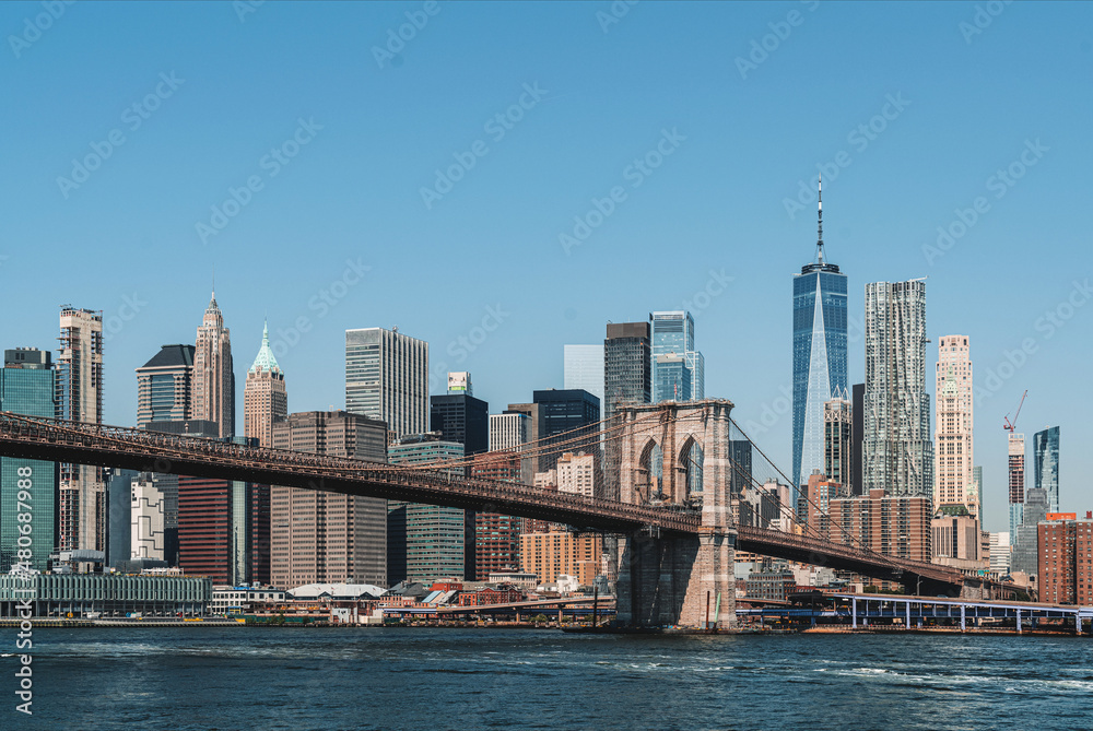 Brooklyn bridge and New York business centre, skyscrapers under blue sky