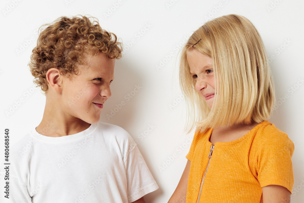 Portrait of cute children casual clothes posing emotions studio isolated background unaltered Portrait of cute children casual clothes posing emotions studio isolated background unaltered