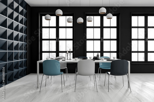 Black and white dining interior with six seats and table near window