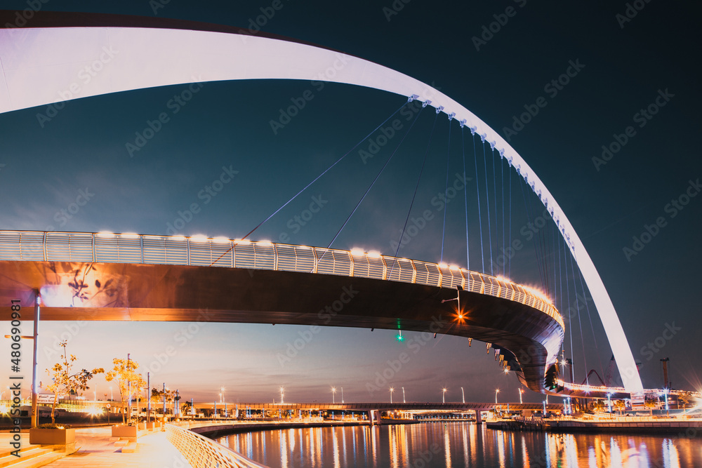 Obraz premium DUBAI, UAE - FEBRUARY, 2018: Dubai Water Canal arch bridge or Tolerance bridge