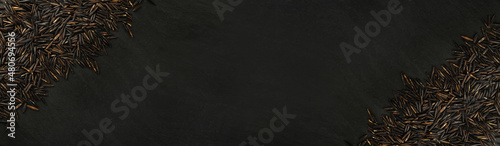 Raw Black Wild Rice on Dark Stone Background