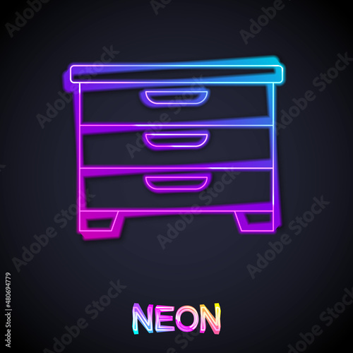 Glowing neon line Chest of drawers icon isolated on black background. Vector