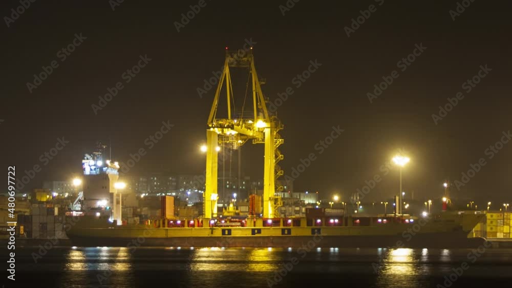 Container Crane unloading a cargo ship at night. 4K Time-lapse Container Crane unloading a cargo ship at night. 4K Time-lapse