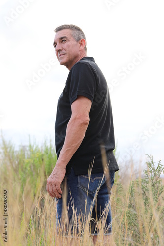 Handsome and healthy man who takes care of himself is 60 years old, in a field in Alicante 