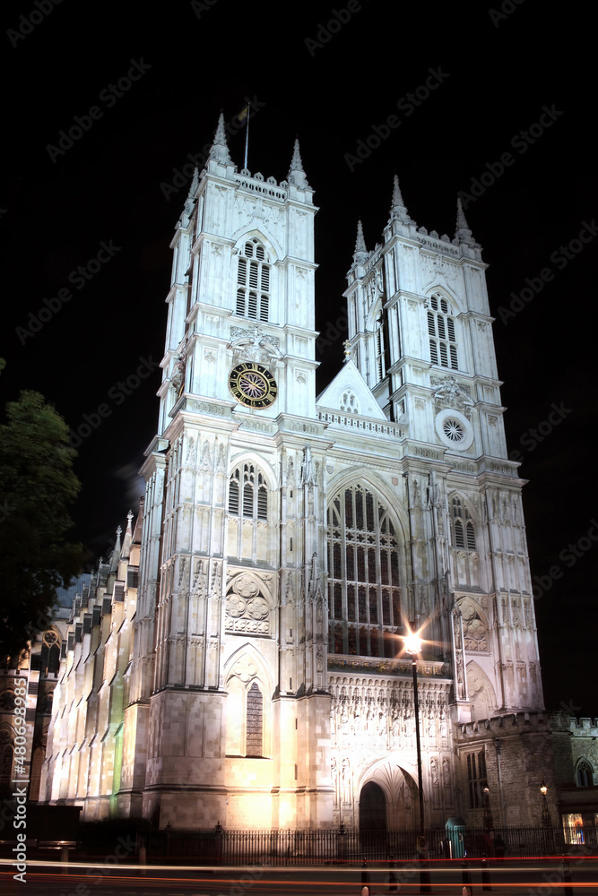 Westminster Abbey in Westminster London England UK at night with vehicle light trails which is a popular travel destination tourist landmark attraction, stock photo image