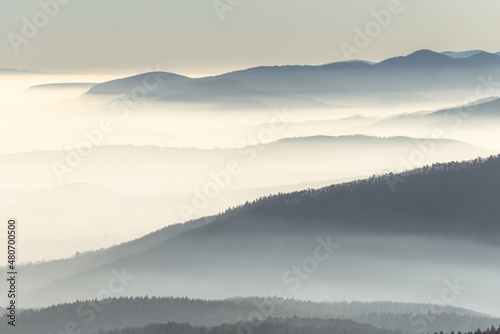 Silhouettes of mountains in the sea of fog in winter.