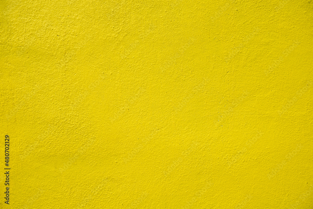 A yellow rough concrete wall in exterior, house concept A yellow rough concrete wall in exterior, house concept
