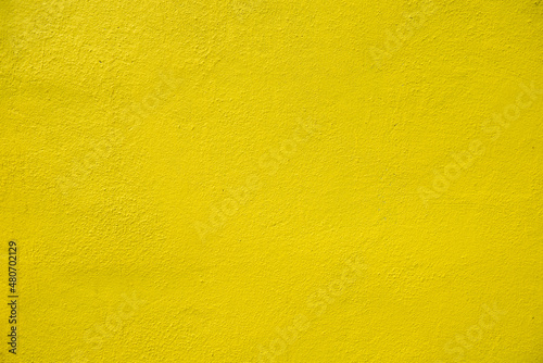 A yellow rough concrete wall in exterior, house concept