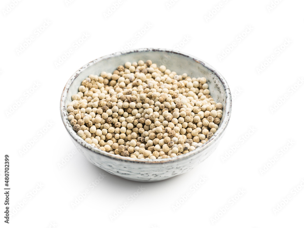 Whole pepper spice. White peppercorn grain in bowl