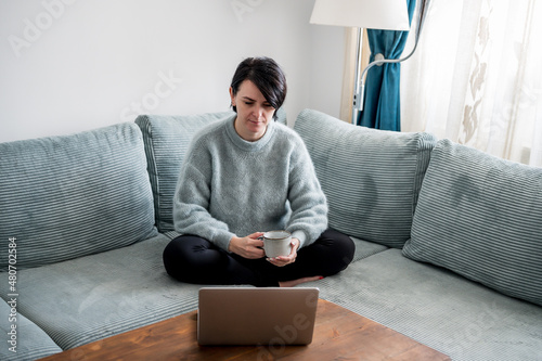 Young woman is resting on a sofa