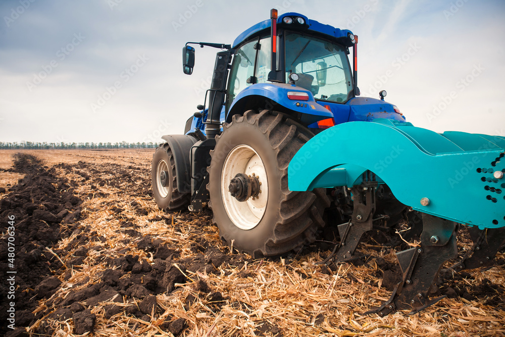 Modern tractor in the field during planting. The concept of agricultural industry. Modern tractor in the field during planting. The concept of agricultural industry.