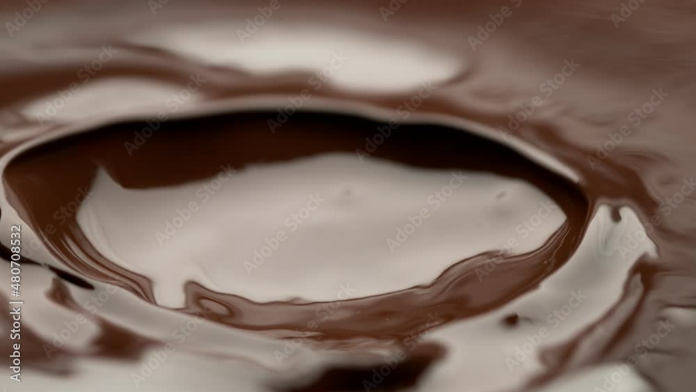 Super slow motion of flowing dark hot chocolate splashes. Filmed with high speed cinema camera, 1000fps. Super slow motion of flowing dark hot chocolate splashes. Filmed with high speed cinema camera, 1000fps.