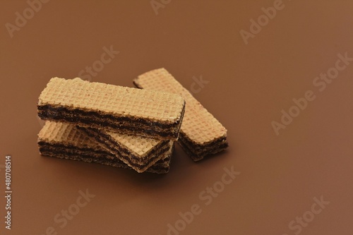 Wafer chocolate biscuits, brown background