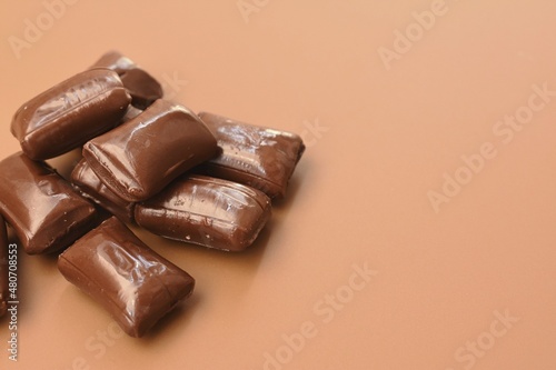 Chocolate candies, brown background