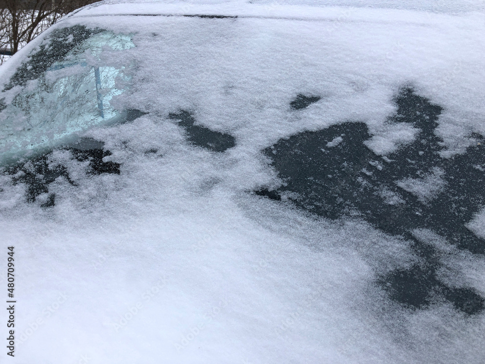 Close up frozen winter car covered snow, view front window windshield on snowy background Close up frozen winter car covered snow, view front window windshield on snowy background