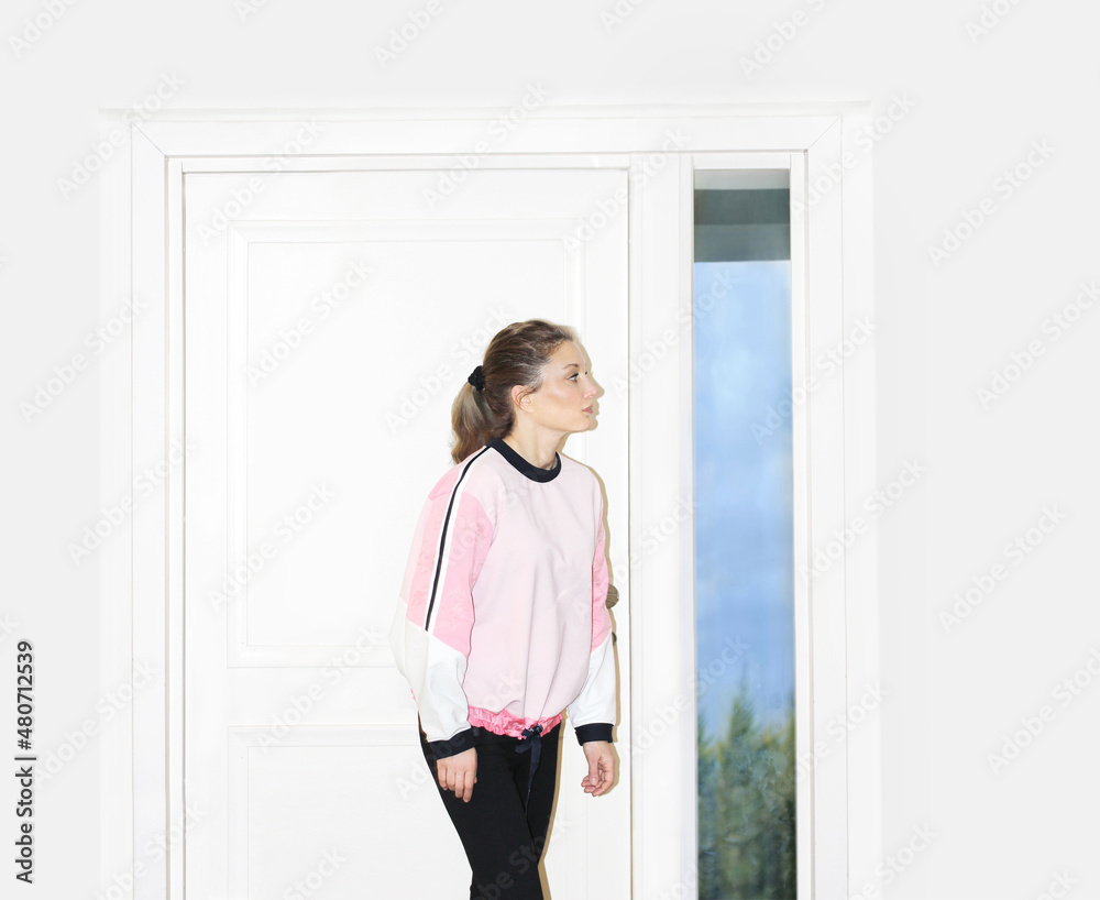 Beautiful woman opening the door of her home