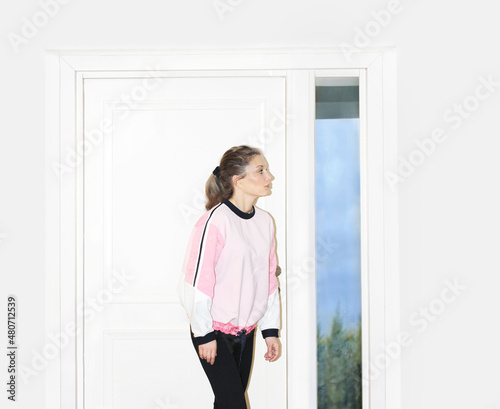 Beautiful woman opening the door of her home