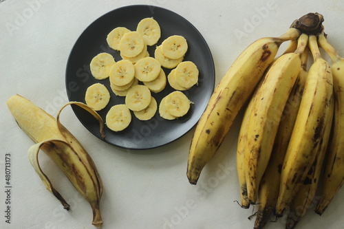 Ripe plantain yellow in colour and thin round plantain slices, photo