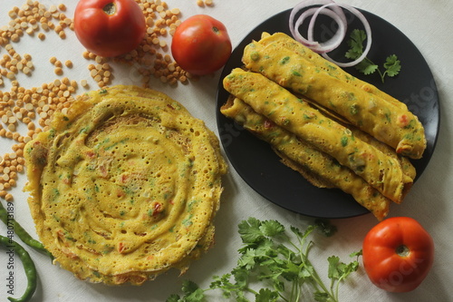 Besan chilla or chickpea pancakes. These are protein rich savoury pancakes made of besan flour or chick pea flour photo