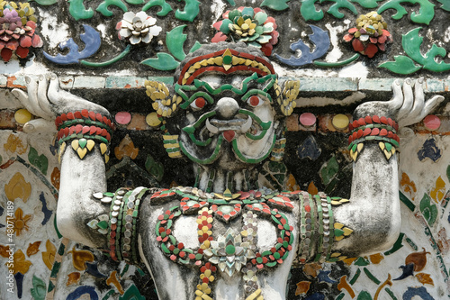 Bangkok, Thailand - January 2022: Detail of a statue in the Wat Arun Buddhist temple located on the banks of the Chao Phraya River on January 16, 2022 in Bangkok, Thailand.