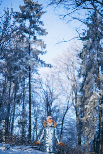 Woman walking in winter park © Petro