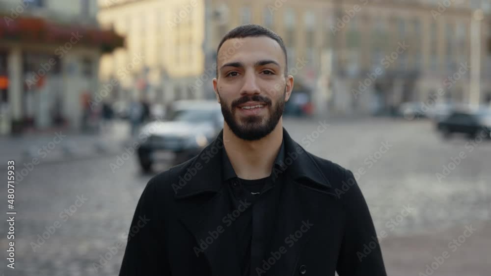 Arabian man in formal wear smiling on camera outdoors Arabian man in formal wear smiling on camera outdoors