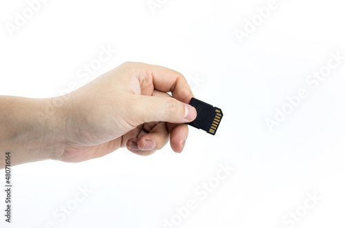 Hand holding a storage card, SD Card isolated on white background.