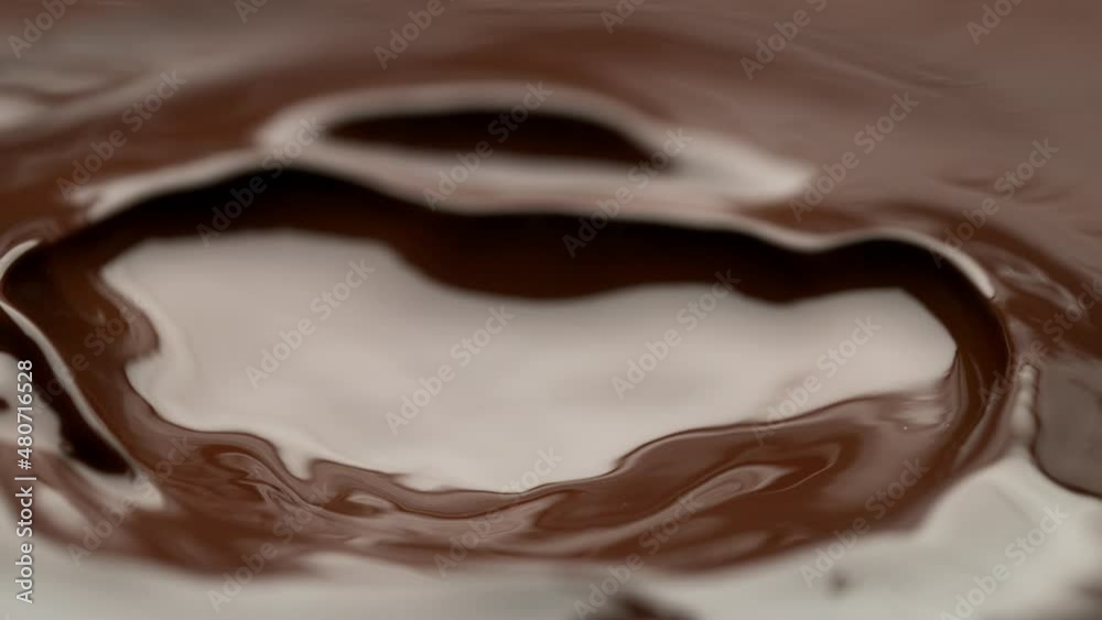 Super slow motion of flowing dark hot chocolate splashes. Filmed with high speed cinema camera, 1000fps. Super slow motion of flowing dark hot chocolate splashes. Filmed with high speed cinema camera, 1000fps.