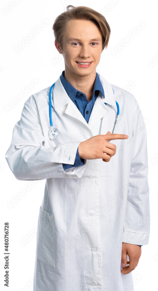 portrait of a student, teenager, young professional. a guy in a medical gown looks at us and points his finger to the side. place for an inscription. I have a stethoscope around my neck portrait of a student, teenager, young professional. a guy in a medical gown looks at us and points his finger to the side. place for an inscription. I have a stethoscope around my neck