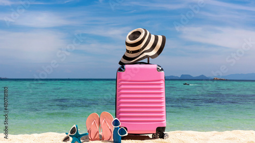 Fototapeta Naklejka Na Ścianę i Meble -  Summer stuff with Pink luggage on the white sand Beach background banner of the tropical travel concept